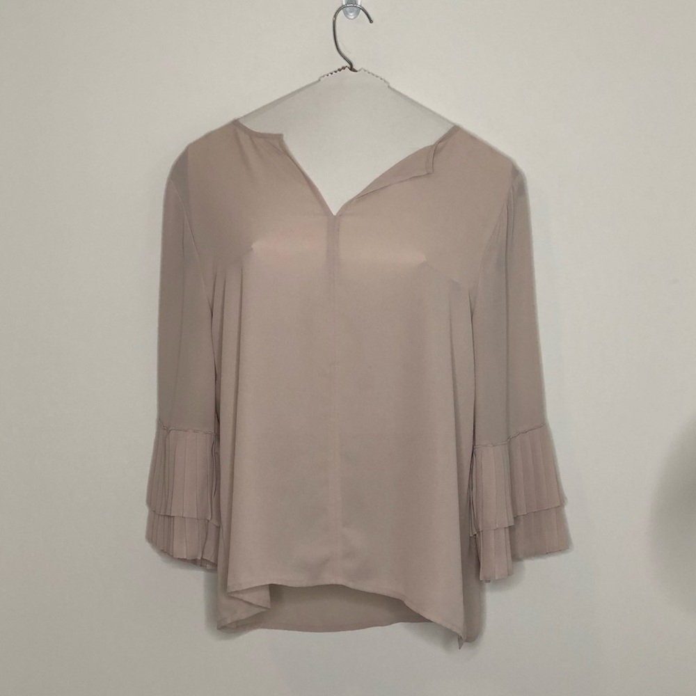 Nude blouse with flared sleeves